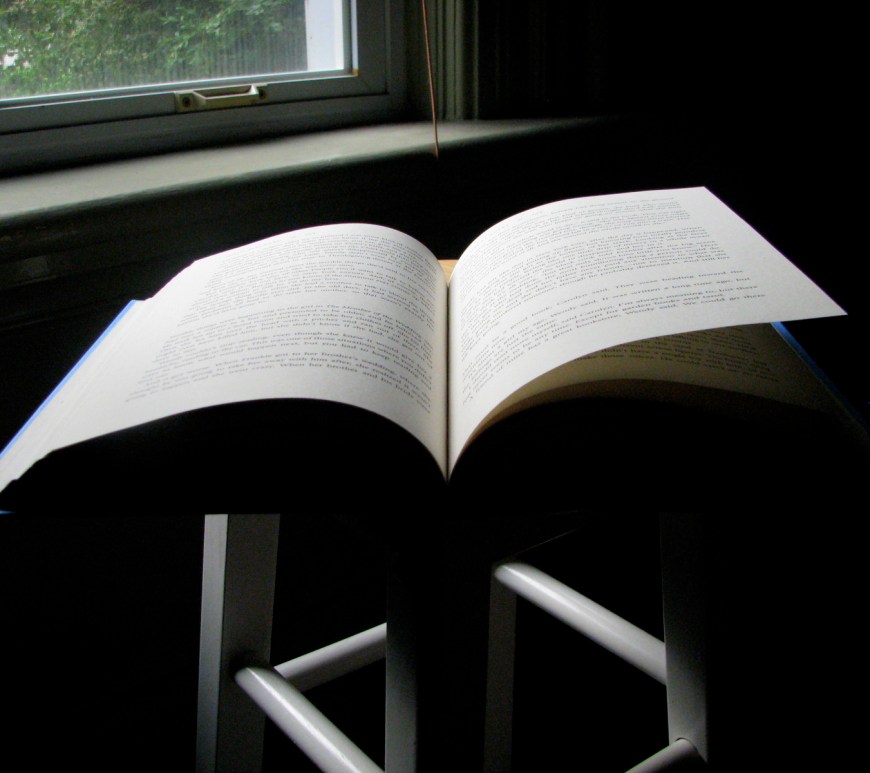 open book on a chair at a window - thetemenosjournal.com