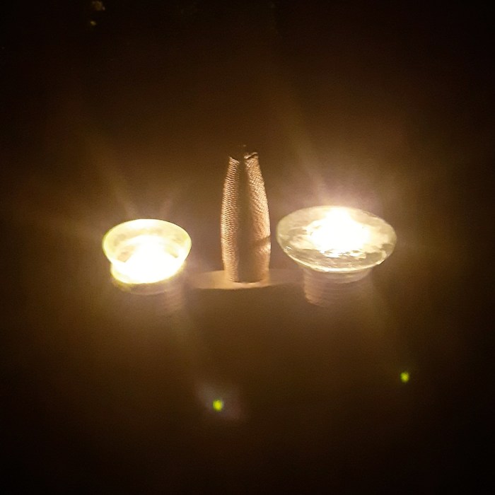 Sword handle illuminated by candles