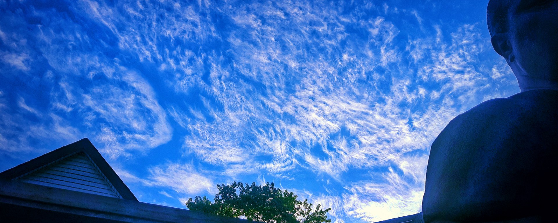 Blue Sky with clouds and person in shadow