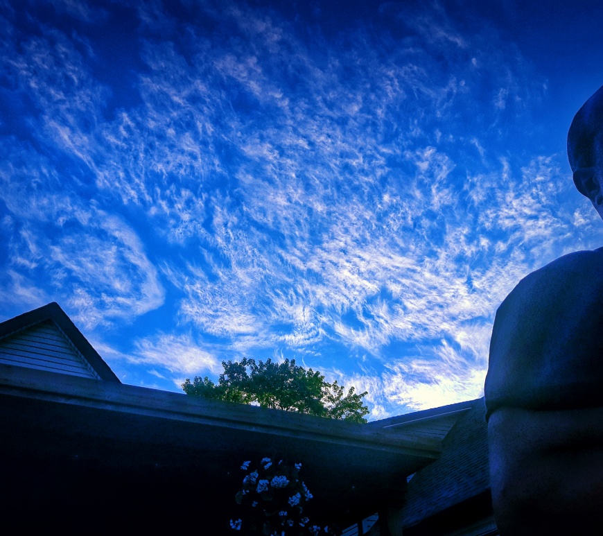 Blue Sky with clouds and person in shadow